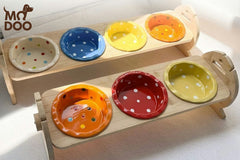 Polka dot patterned ceramic cat bowl with an adjustable bamboo stand for cats and small dogs